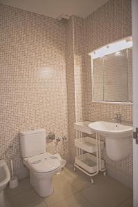 a bathroom with a toilet and a sink at Duplex Ancla in L'Ametlla de Mar