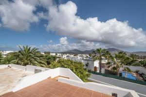 einen Blick vom Balkon eines Hauses mit Palmen in der Unterkunft Casa Juleta barrierefrei in Playa Blanca