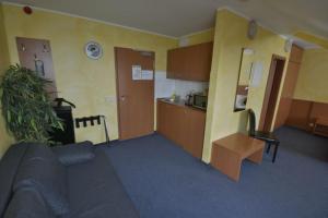 a living room with a couch and a kitchen at Hotel Nord in Rheinbach