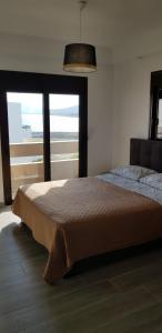 a bedroom with a bed with a view of the ocean at Sea Breeze 2 in Haraki +24 photos