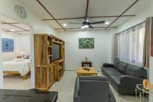 a living room with a couch and a ceiling fan at Alona Apartments in Panglao