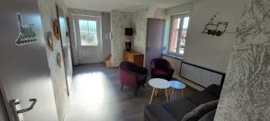 a living room with a couch and chairs and a table at LA HALTE 19 in Ban-sur-Meurthe-Clefcy