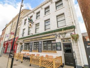 a building with tables and chairs in front of it at 8 Hampton Road in North Shields