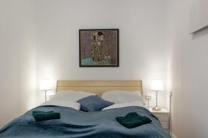 a bed with two pillows and a picture above it at Basic 2BR Apt Perfectly Connected&Well Positioned in Vienna