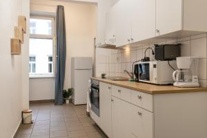 a kitchen with white cabinets and a counter top at Basic 2BR Apt Perfectly Connected&Well Positioned in Vienna