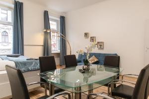 a living room with a glass table and chairs at Basic 2BR Apt Perfectly Connected&Well Positioned in Vienna