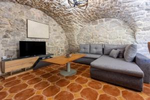 a living room with a couch and a table at Apartments NEVEN in Grižane