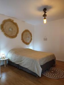 a bedroom with a bed and two baskets on the wall at Au Grand Bonheur - Gîte Padirac - Rocamadour in Miers