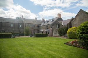 un gran patio frente a un gran edificio en Collingwood Arms Hotel en Cornhill-on-tweed