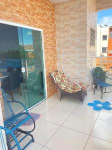 un patio con 2 sillas, un sofá y una mesa en Pousada Mineira en Barreirinhas