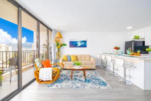 a kitchen and living room with a balcony with a view at Remodeled 1BR Condo, Ocean Views with Free Parking! in Honolulu