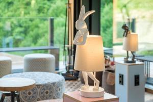 a lamp with a statue of a rabbit on a table at Oberstdorf Hostel in Oberstdorf