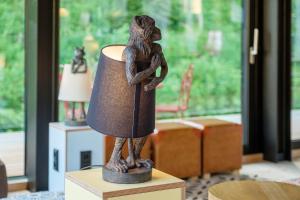 a statue of a monkey holding a lamp on a table at Oberstdorf Hostel in Oberstdorf
