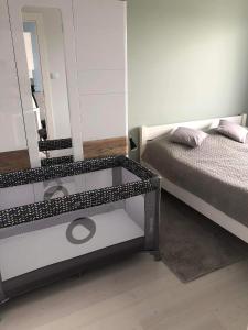 Apartament Future في كولوبرزيغ: غرفة نوم مع مرآة بجانب سرير