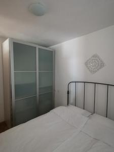 a bedroom with a bed with a glass door at Istrian old town apartment in Koper +28 photos