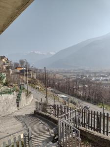 a set of stairs leading down a hill with a road at Casa vacanze il Picchio Rosso in Mantello