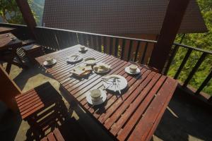 an overhead view of a wooden table on a deck at Ella Camelot in Ella