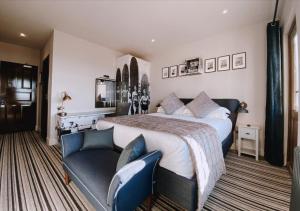 a large bedroom with a large bed and a couch at The Woolacombe Bay Hotel in Woolacombe
