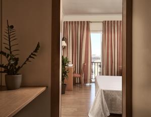 a hotel room with a bed and a balcony at Strada Marina Hotel in Zakynthos