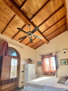 a bedroom with a ceiling fan and a bed at Podere La Branda in Vetralla