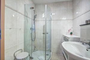 a bathroom with a glass shower and a sink at Ostseeresidenz Gorki- Park - 11 mit Wellness und Schwimmbad in Bansin