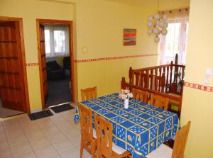 a dining room with a table with a blue and white at Juhász Apartman in Gyenesdiás +20 photos