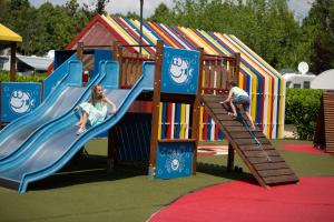 a boy and a girl playing on a slide at a playground at Campeggio Europa Silvella in San Felice del Benaco +135 photos