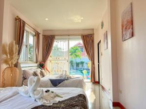 a hotel room with two beds and a large window at Mantra Pattaya Pool Villa-Pool with Jacuzzi in Pattaya-Pet-Friendly in Jomtien Beach