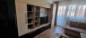 a living room with a television and a couch at Dacia Apartment in Timişoara