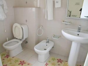 La salle de bains blanche est pourvue de toilettes et d'un lavabo. dans l'établissement Villa Franca B&B, à Turi