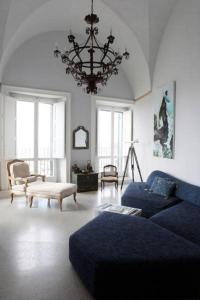 ガリポリにある4 Balconi House-San Gregorio palazzo unico vista mareのリビングルーム(青いソファ、シャンデリア付)