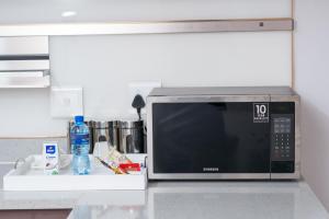 un four micro-ondes installé au-dessus d'un comptoir de cuisine dans l'établissement Moonpopson Luxury Apartments, Fourways Sandton, à Sandton