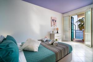 a bedroom with a large bed and a balcony at Loft Balcone Sul Mare in Letojanni