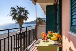 a table with a bowl of fruit on a balcony overlooking the beach at Loft Balcone Sul Mare in Letojanni