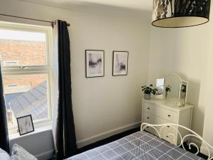 a bedroom with a bed and a window at 2 bedroomed house close to Cleethorpes seafront in Cleethorpes