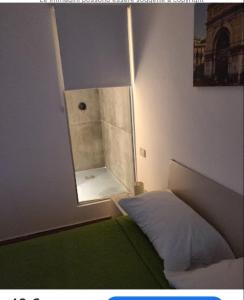 a small room with a bed and a mirror at Antadia in Palermo