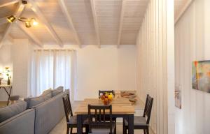 a dining room with a table and a couch at Kamari Luxury Apartment in Lefkada Town
