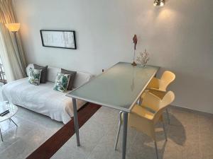 a glass table in a living room with a couch at Apartment PM237 - Paraiso Maspalomas in Playa del Ingles