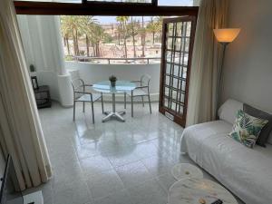 a living room with a table and a couch at Apartment PM237 - Paraiso Maspalomas in Playa del Ingles