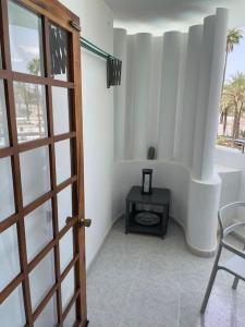 a room with a door and a table and a chair at Apartment PM237 - Paraiso Maspalomas in Playa del Ingles +22 photos