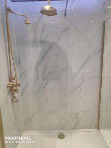 a shower with a glass door with a shower head at 29 Marine Crescent in Waterloo