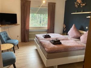 a bedroom with a bed with two towels on it at Bed & Breakfast Weisser Stein in Schmallenberg