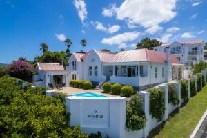 a villa with a swimming pool in a resort at Westhill Luxury Guest House in Knysna