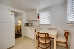 a kitchen with a table and chairs and a refrigerator at Empress Motel in Ocean City