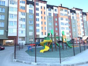 a playground with a slide in front of a building at Комфортна квартира. Поруч парк in Ternopilʼ