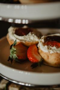 a plate with two donuts with strawberries on it at The Woolacombe Bay Hotel in Woolacombe