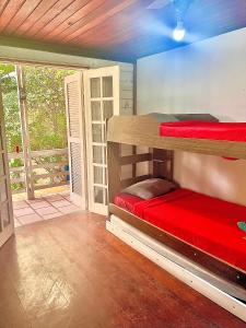 a room with two bunk beds in a room at Pousada Praia do Recreio in Rio de Janeiro