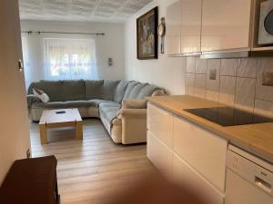 a living room with a couch and a table at Apartment Balatonbereny 2 in Balatonberény