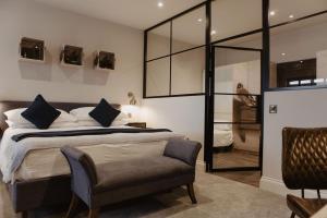 a bedroom with a large bed and a chair at The Woolacombe Bay Hotel in Woolacombe