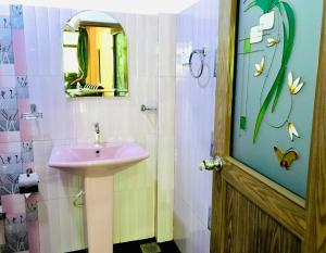 a bathroom with a sink and a mirror at Gangadiya Lodge in Sigiriya +56 photos